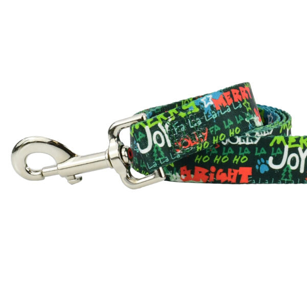 Close-up of holiday-themed dog leash with green background and colorful festive words like “Merry,” “Joy,” and “Bright” – 2 Hounds Design - Earthstyle