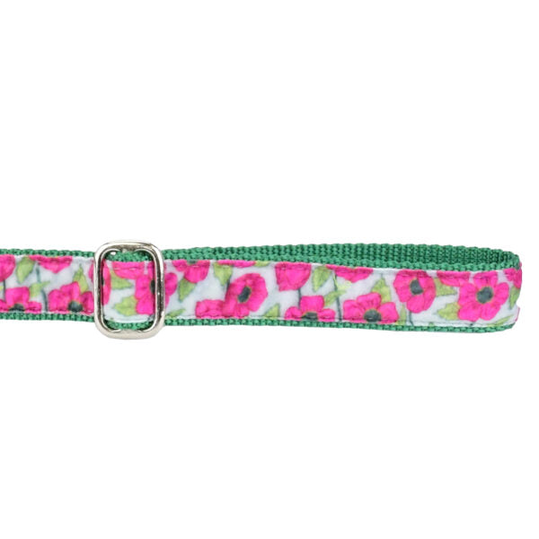 Close-up of pink floral pattern on green dog leash handle with adjustable feature by 2 Hounds Design