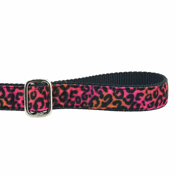 Close-up of black leopard print in pink and orange background velvet dog leash handle with adjustable feature by 2 Hounds Design